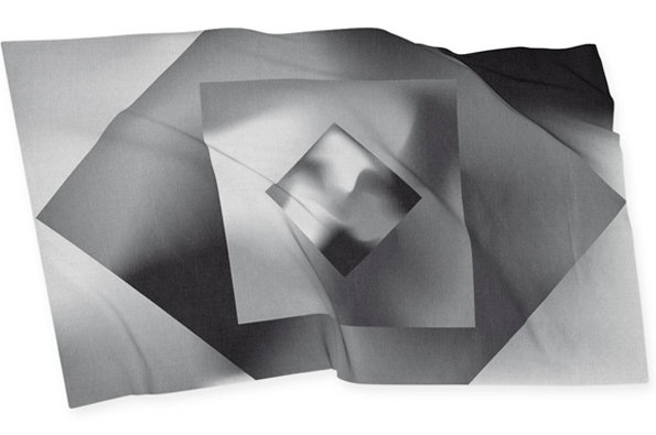A black and white 3D render of a draped fabric. The material is printed with a series of nested, overlapping squares and diamonds in varying shades of grey.