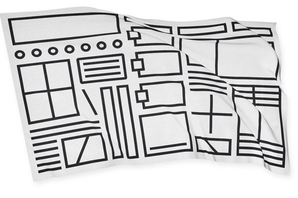 A white blanket featuring a black line drawing of a website wireframe. The abstract layout consists of various rectangles, circles and lines across the fabric.