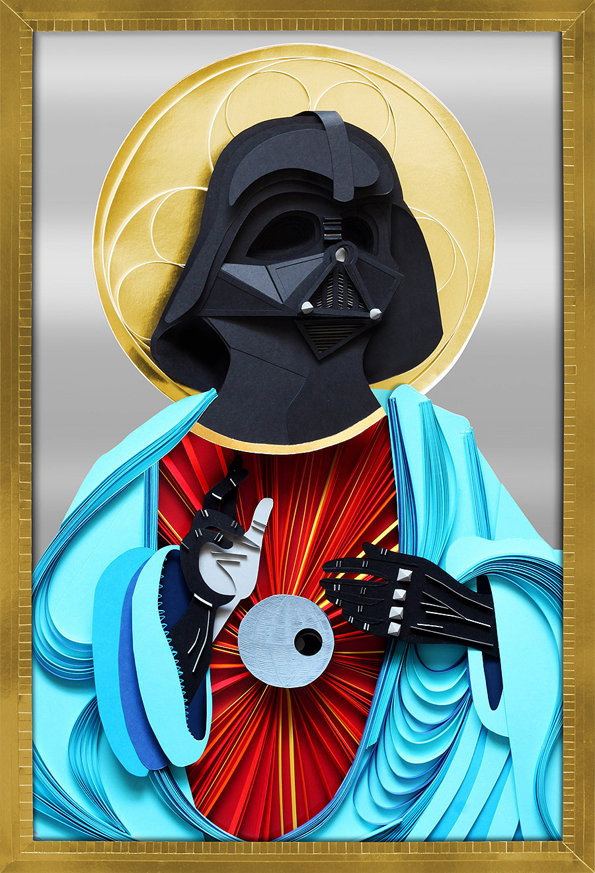A paper sculpture of Darth Vader depicted as a religious icon. He wears a bright blue robe and is framed by a golden halo.