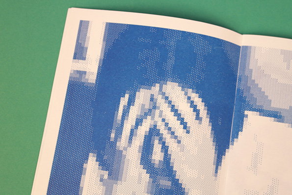 A close-up of a printed page featuring a blue and white halftone image. The graphic depicts a person’s hands held up to their face.