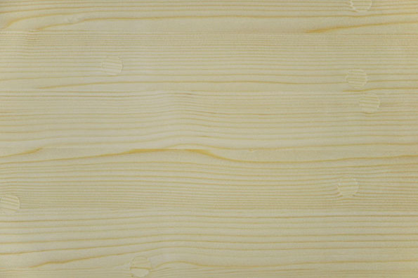 A close-up of a pale, light-coloured wood grain. Fine horizontal lines and small knots run across the surface.