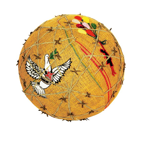 A spherical sculpture wrapped in yellow fabric and bound with criss-crossing twine. It features a white dove carrying an olive branch and a colourful floral motif.
