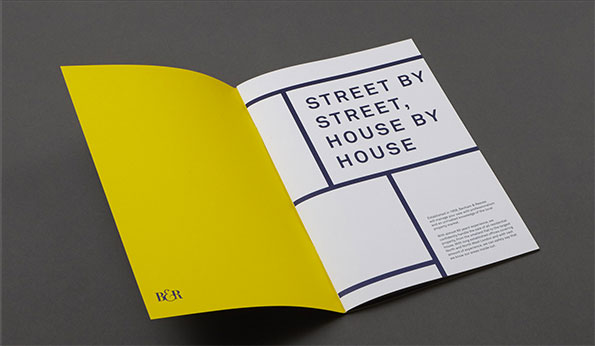 An open brochure with a bright yellow left page and a white right page. The right page features a bold typographic layout that reads “STREET BY STREET, HOUSE BY HOUSE”.