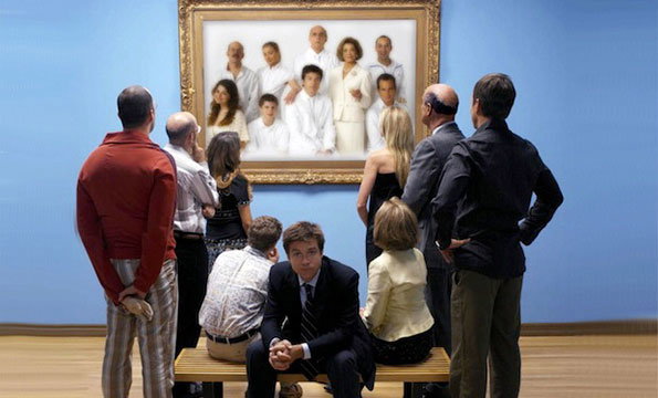 A group of people stand in a gallery, looking at a large framed painting of a family dressed in white. One person sits on a bench in the foreground, facing the camera with a solemn expression.