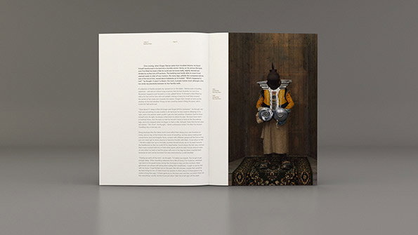 An open book shows a page of text opposite a full-page photograph. The photo depicts a person seen from behind, wearing a yellow robe and carrying a large, ornate drum on their back.