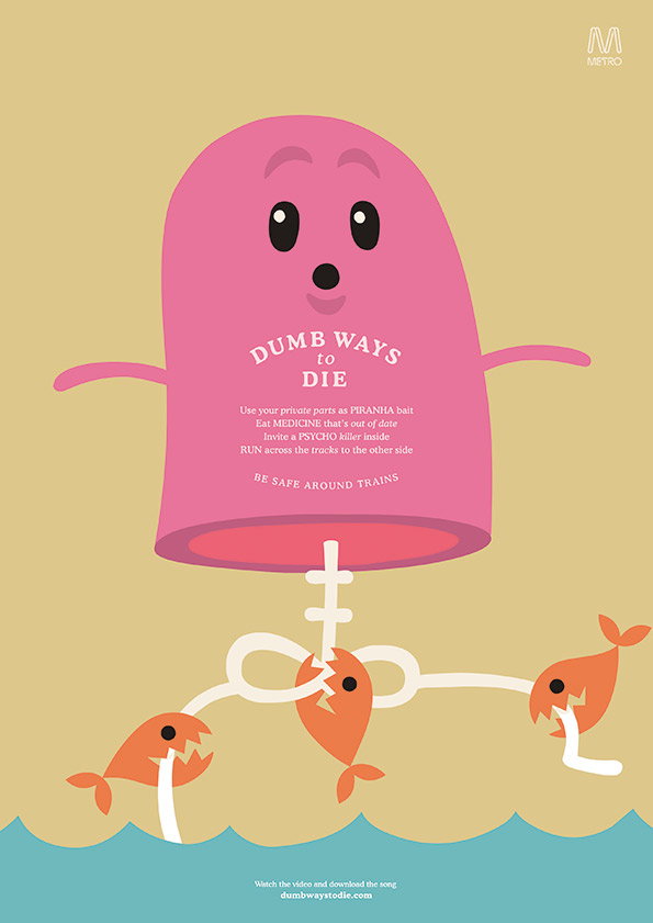 An illustration for the “Dumb Ways to Die” campaign featuring a pink, bean-shaped character. The character is being pulled underwater by three orange piranhas attached to a string. Text on the character’s chest reads “Dumb Ways to Die” followed by a list of mishaps and the warning “Be safe around trains.”