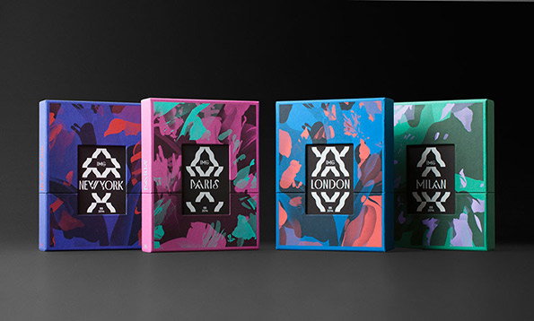 Four colourful boxes stand in a row against a dark background. Each features a bold, abstract pattern and a central black label with a city name: “New York”, “Paris”, “London” and “Milan”.