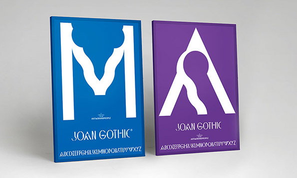 Two books stand side by side against a plain grey background. One is blue with a large white “M” and the other is purple with a large white “A”, both featuring fluid, organic shapes. Both covers display the text “Joan Gothic” and a full alphabet across the bottom.