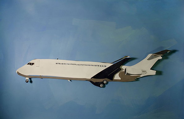 A collage of a white aeroplane against a painterly blue background. The plane is constructed from cut paper, with a grey underside and dark wings.
