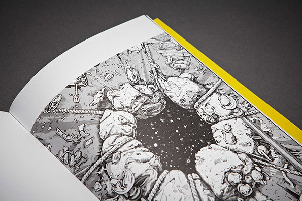 An open book shows a black and white illustration of a circular arrangement of jagged rocks. The rocks surround a dark, starry void, with ropes and debris scattered across the surface.