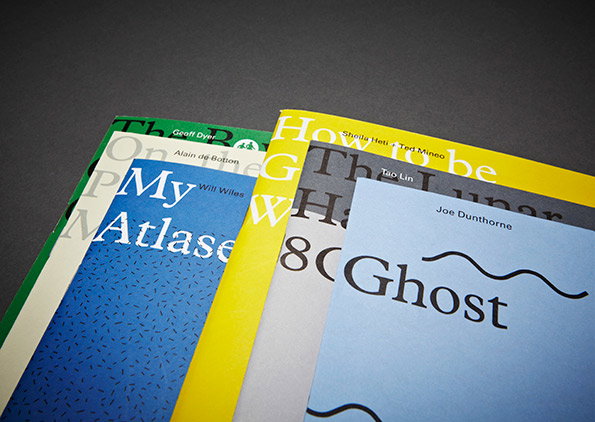 A fan of five colourful book covers laid against a dark grey background. The visible titles include “My Atlas” and “Ghost”, with author names such as Joe Dunthorne and Alain de Botton.
