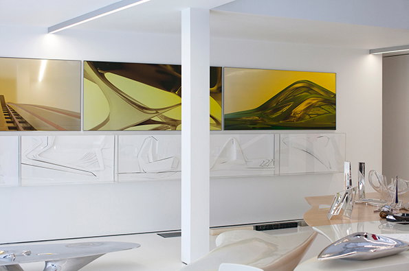 A bright, white minimalist interior featuring a series of large abstract paintings on a wall. The top row shows fluid, organic shapes in yellow and green, while the bottom row consists of white-on-white linear compositions.