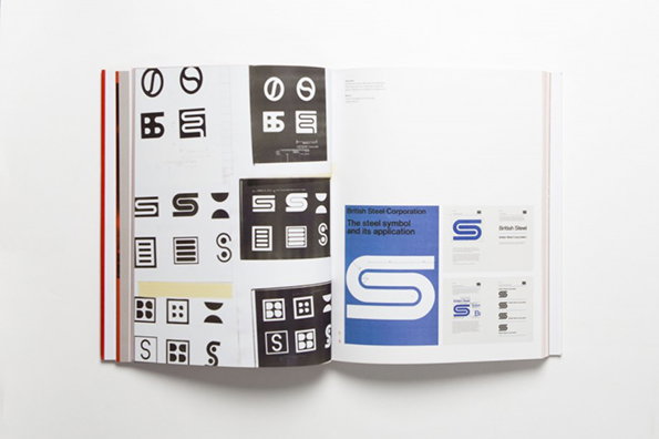 An open book displays a series of graphic studies for the British Steel logo. The pages show various iterations of a stylised “S” symbol in black and white, alongside a final blue version titled “British Steel Corporation”.