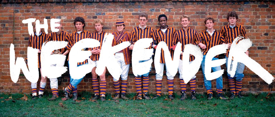 Ten people in orange and navy striped sports kits stand in a line against a brick wall. The words “THE WEEKENDER” are written across the centre in bold, white, hand-painted lettering.