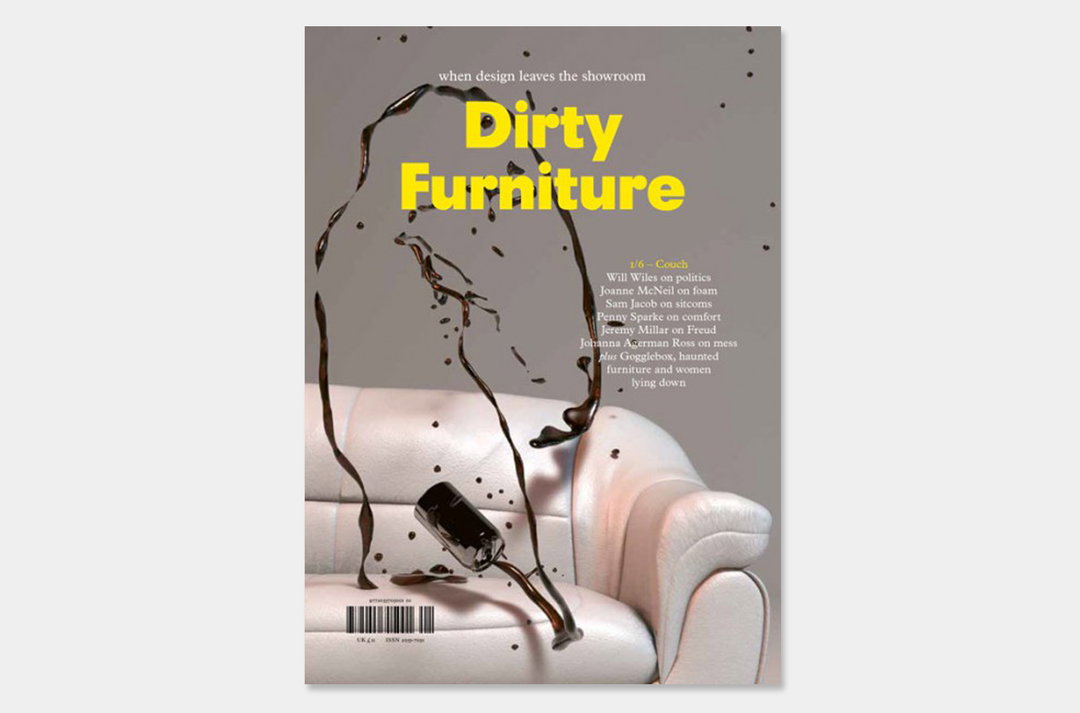 A magazine cover titled “Dirty Furniture” in bold yellow type. A dark liquid splashes across a white leather sofa, with a tipped-over glass resting on the seat.
