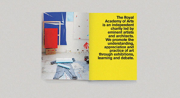 An open booklet shows a photo of an artist's studio on the left and a yellow page of text on the right. The text reads, “The Royal Academy of Arts is an independent charity led by eminent artists and architects. We promote the understanding, appreciation and practice of art through exhibitions, learning and debate.”