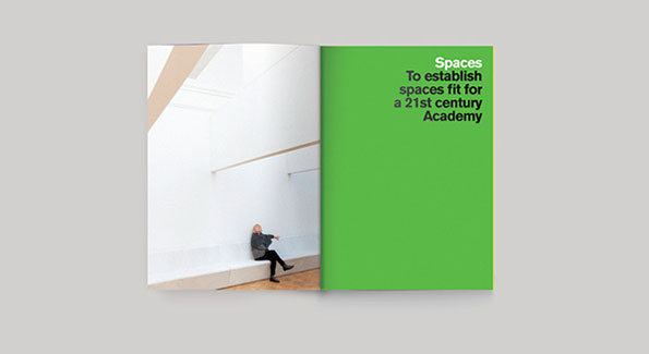 An open brochure shows a person sitting against a white wall in a bright, minimalist room. The opposite page is solid green with the text “Spaces To establish spaces fit for a 21st century Academy”.