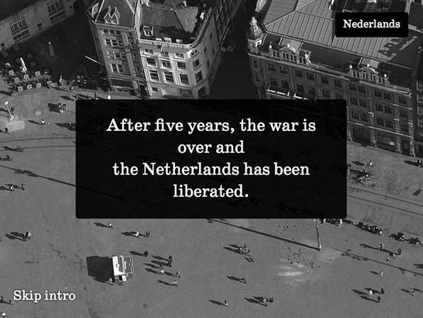 A high-angle black and white photograph of a city square with people scattered across the open space. A black text box in the centre reads “After five years, the war is over and the Netherlands has been liberated.”