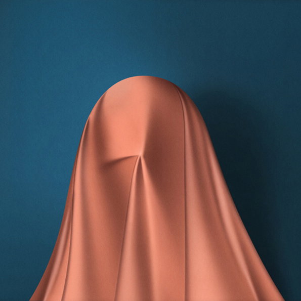 A figure is completely draped in a smooth, peach-coloured fabric against a deep blue background. The cloth clings to the shape of a head and shoulders, creating soft folds and shadows.