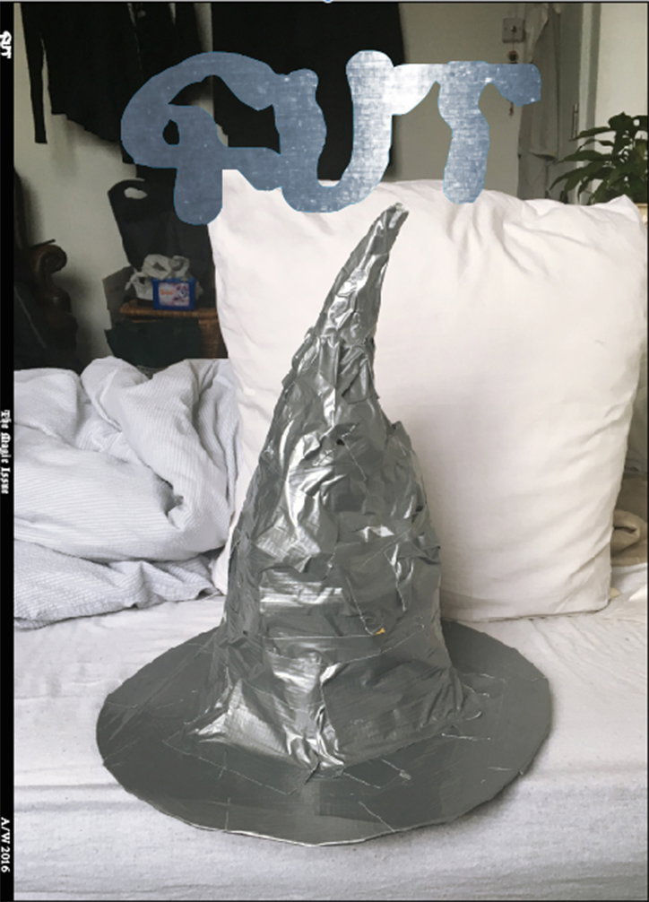 A pointed wizard’s hat made from silver duct tape sits on a white bed. A large, stylised silver wordmark is laid over the top of the image.