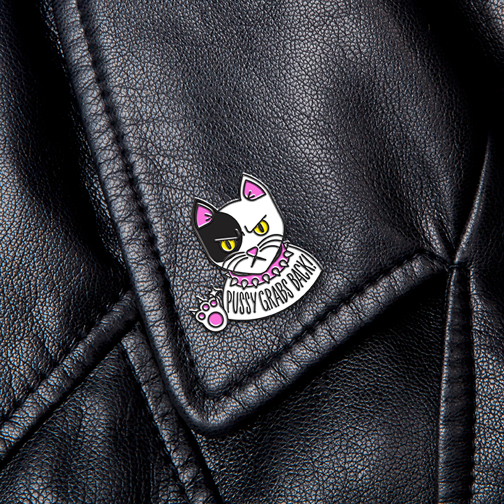 Sagmeister-Walsh-Pins-Won't-Save-the-World_SW_PussyGrabsBack-Cat.png