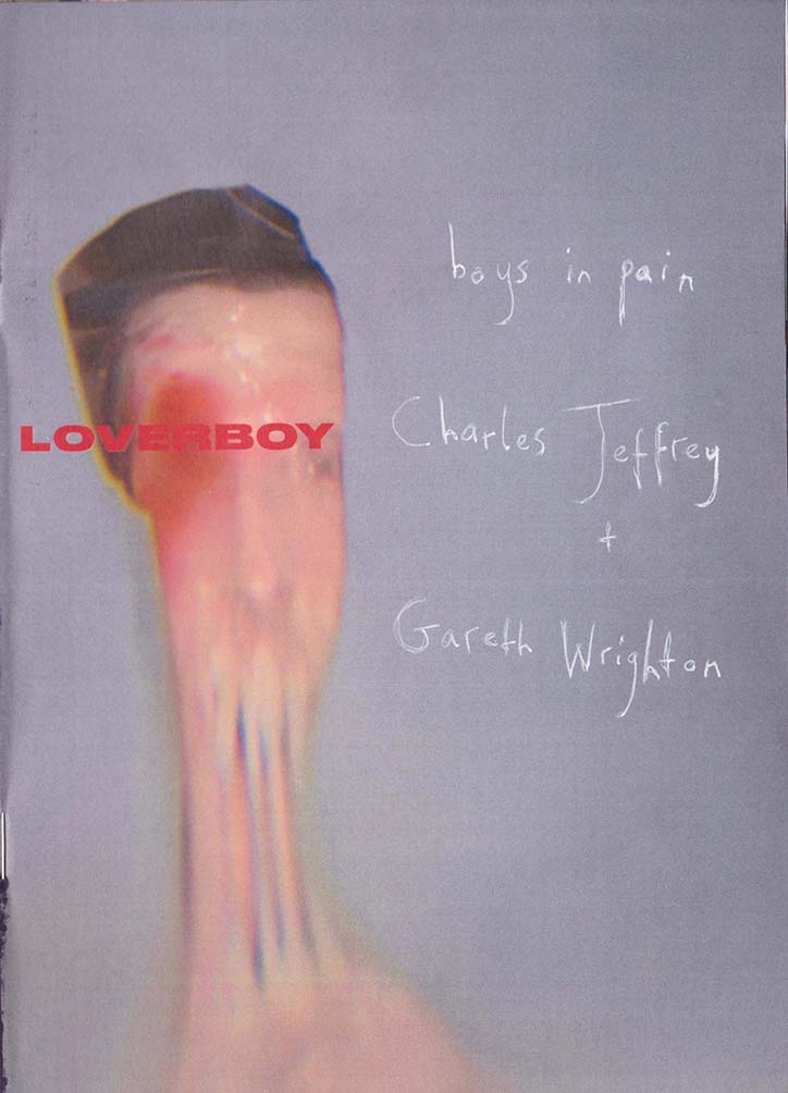 A blurred, distorted portrait of a person on a pale purple background. Red text reads “LOVERBOY”, while handwritten white text reads “boys in pain”, “Charles Jeffrey” and “Gareth Wrighton”.