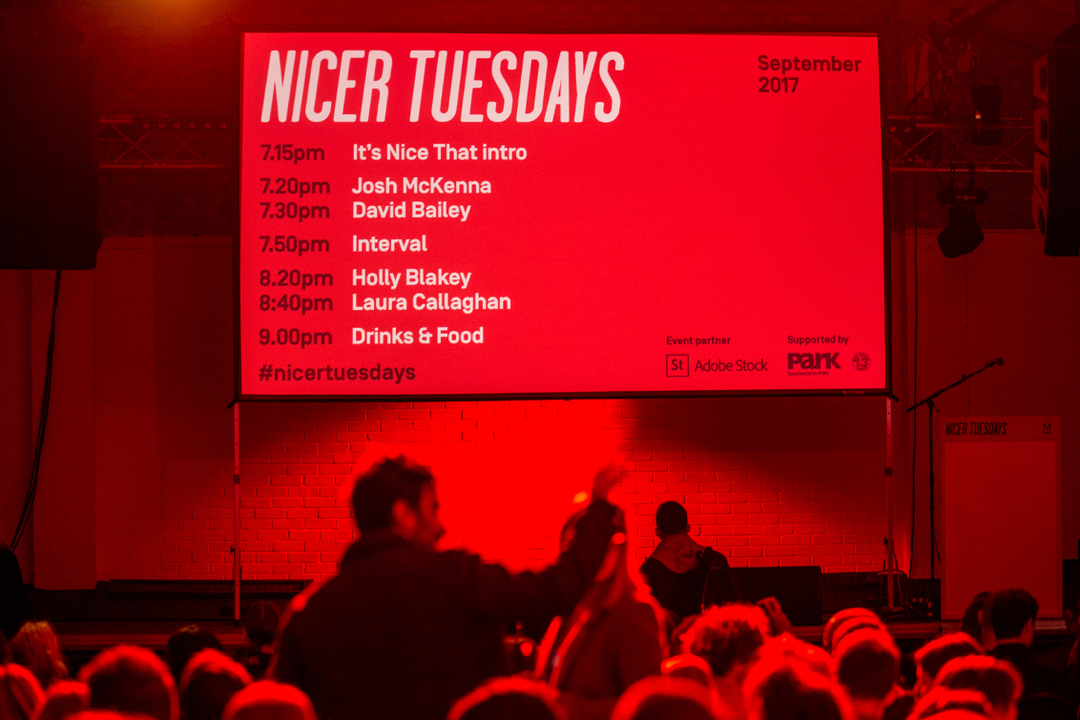 A large red screen displays the schedule for “Nicer Tuesdays” in September 2017. The line-up includes speakers Josh McKenna, David Bailey, Holly Blakey and Laura Callaghan. Below the screen, a crowd of people is gathered in a dimly lit room, with one person raising their arm.