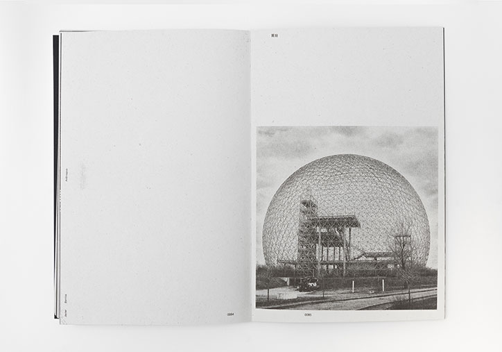 An open book shows a black and white photograph on the right-hand page. The image features a large, geodesic dome structure enclosing a complex industrial building.