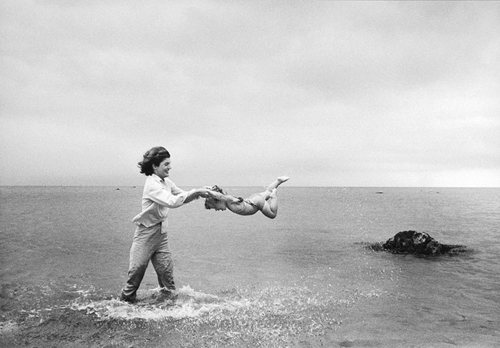 Mark-Shaw_Kennedys_Proud-Galleries_photography_itsnicethat_Jackie-swings-Caroline-in-the-shallows-at-Hyannis-Port_-1959.jpg