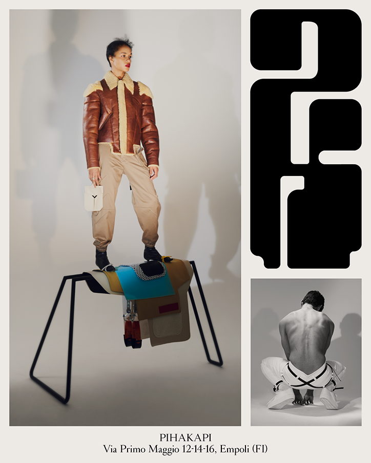 A person stands atop a sculptural, saddle-like piece of furniture, wearing a brown leather jacket and beige trousers. To the right, a black and white graphic pattern sits above a black and white photo of a person crouching with their back to the camera. Text at the bottom reads “PIHAKAPI” and “Via Primo Maggio 12-14-16, Empoli (FI)”.