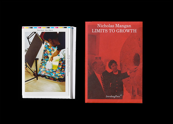 Two books are set against a black background. One is open to a page showing a person working with a yellow object on a colourful patterned surface, while the other is a red cover titled “Nicholas Mangan Limits to Growth”.