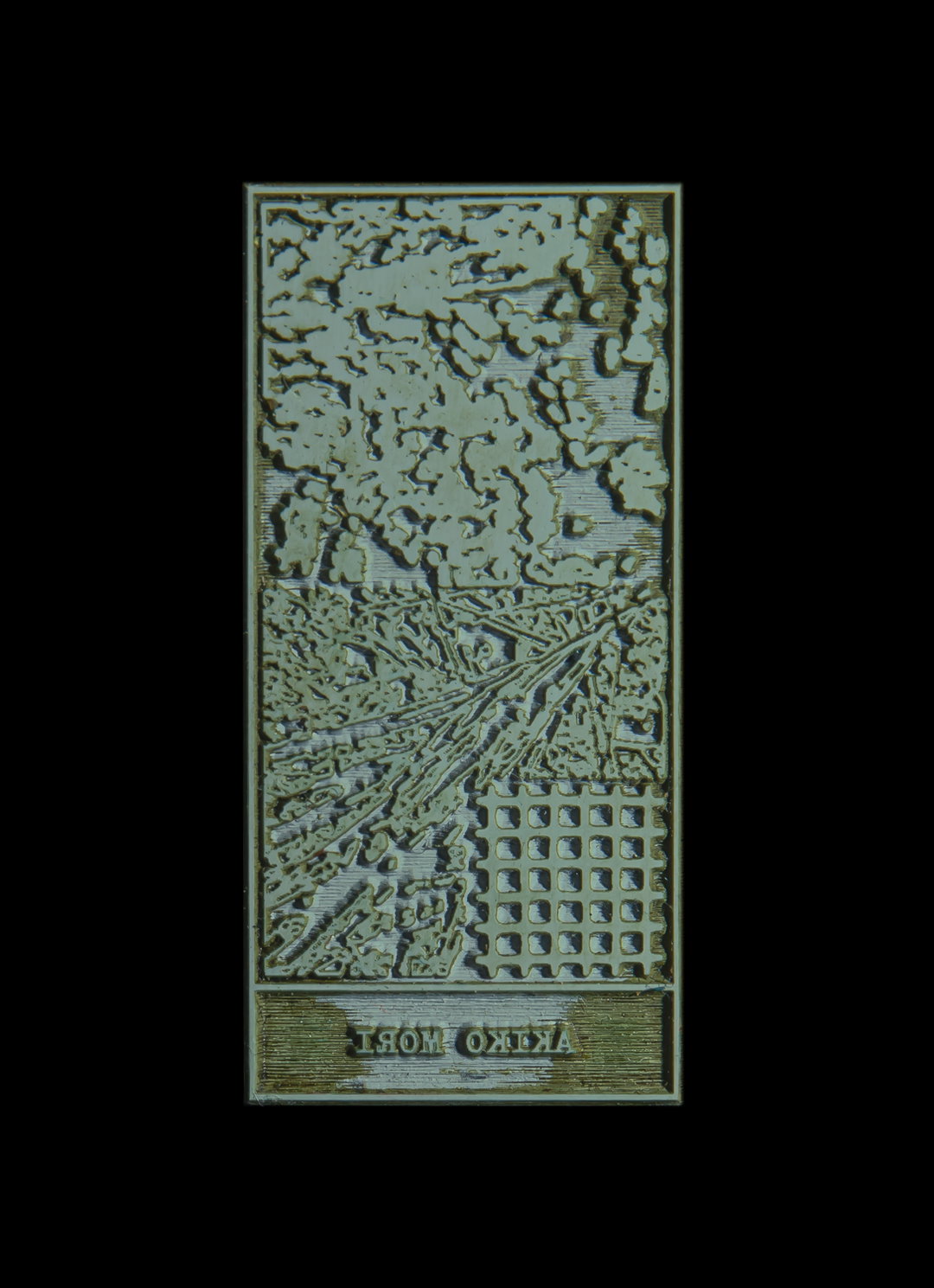 A textured, pale green rectangular relief sculpture. The surface features organic, cloud-like forms at the top, a chaotic landscape in the middle, and a grid of small squares at the bottom right. Mirrored text at the base reads “AKIKO MORI”.