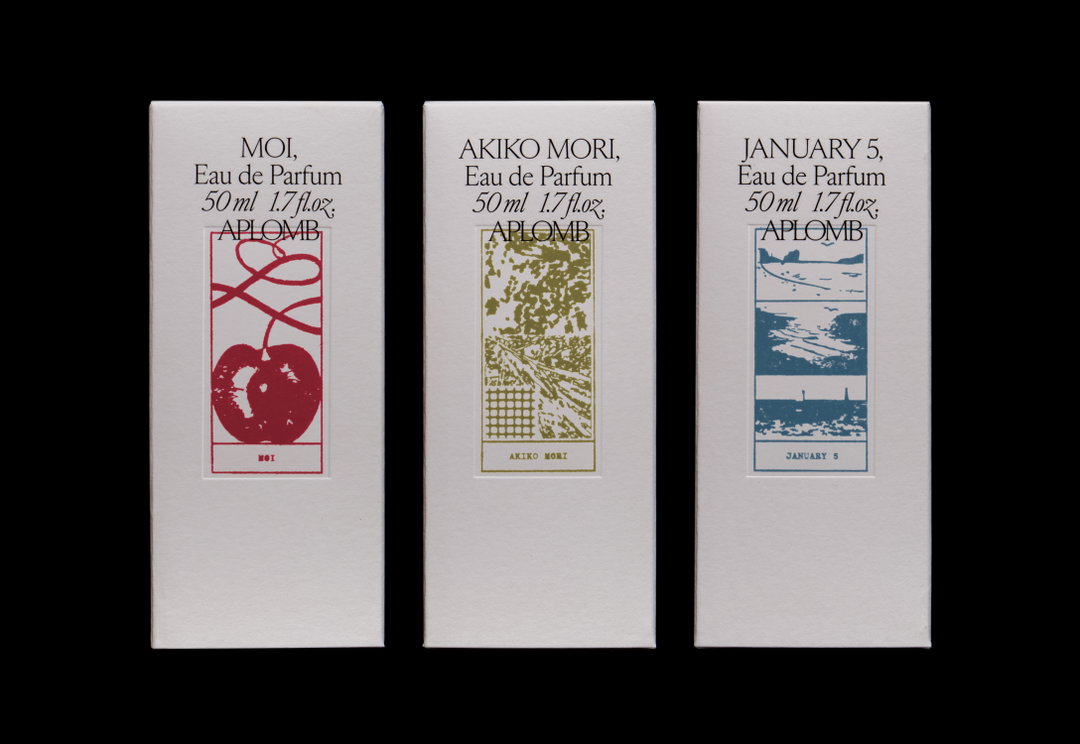 Three white rectangular perfume boxes stand side by side against a black background. Each features a different coloured illustration and text including “Eau de Parfum”, “50 ml 1.7 fl.oz.” and “Aplomb”.