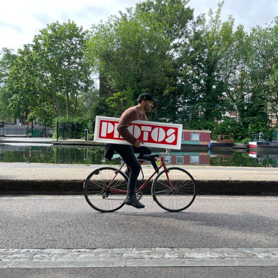 Copy of Rafa cycling with sign.JPG