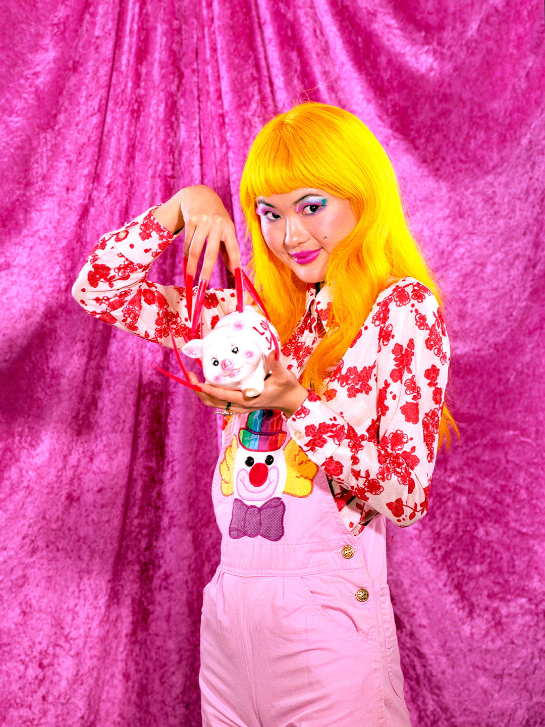 Smiling woman playing with piggy bank.jpg