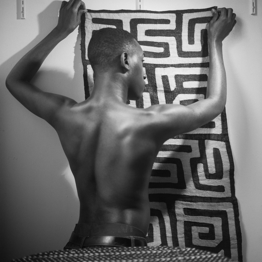 john edmonds foam paul huf award winner 2021 photography itsnicethat_Youg man holding up Kuba cloth 2019 C John Edmonds.jpg