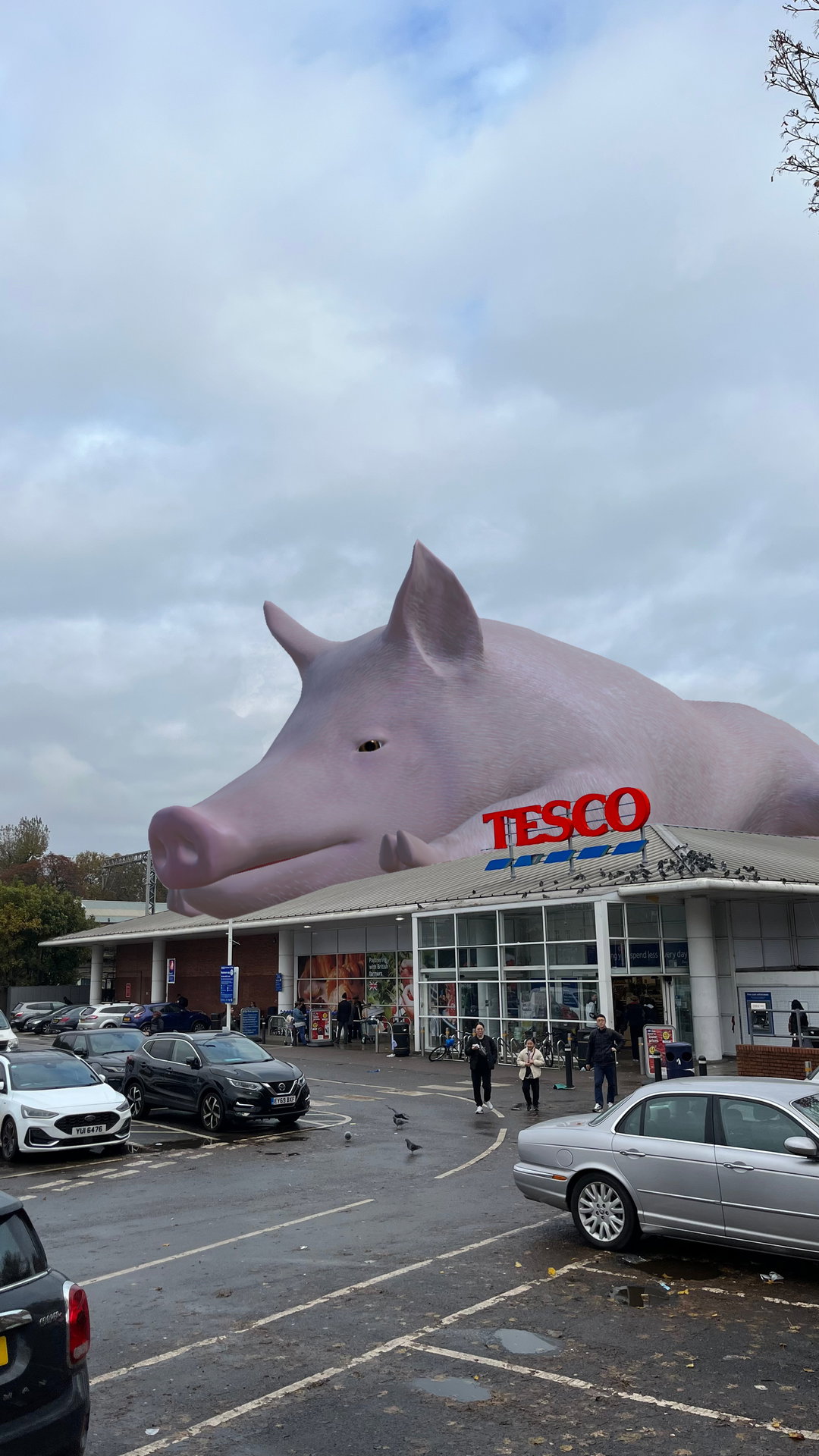 Huge squealing AR pig appears on top of UK Tescos and Barclays